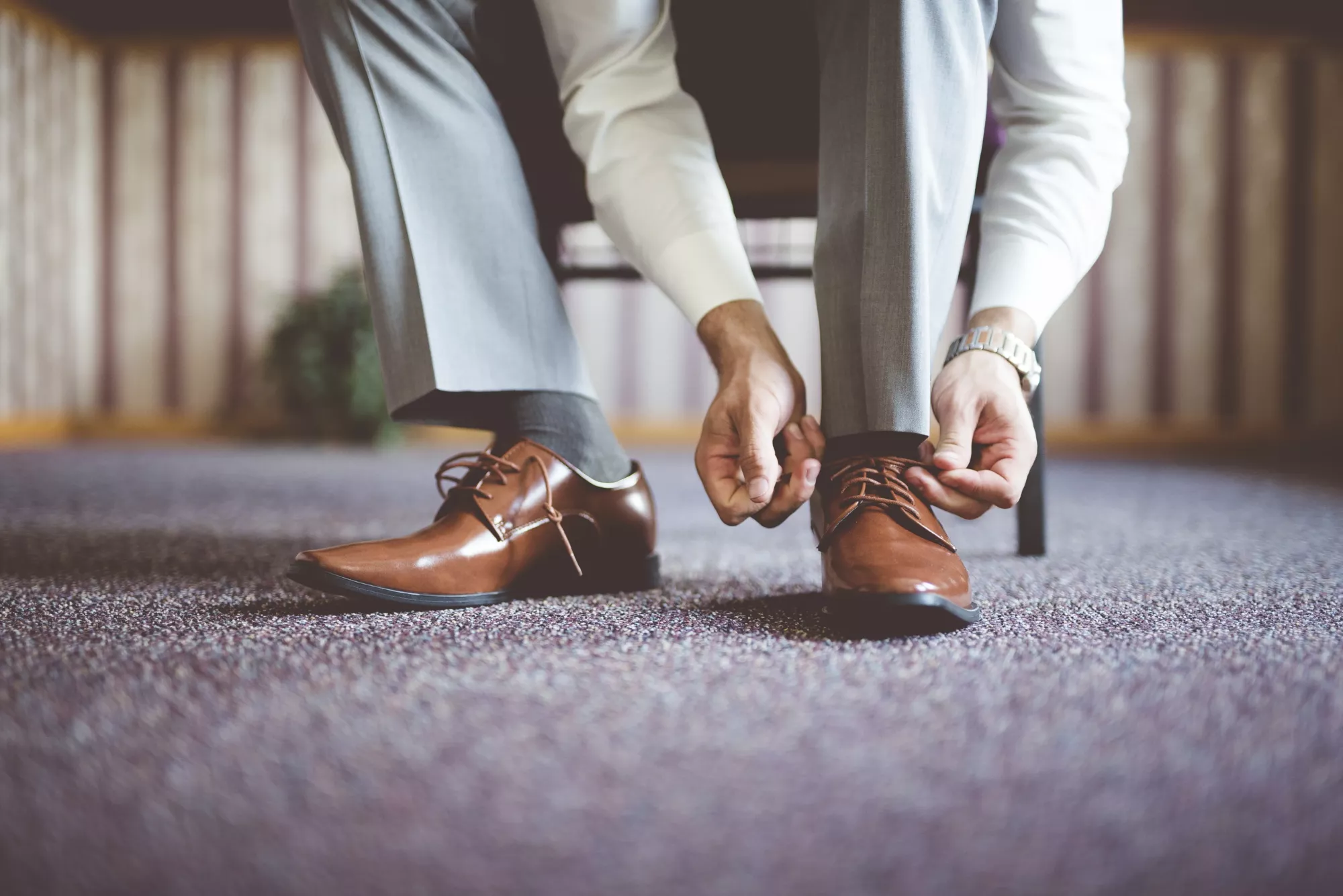 closeup-shot-male-tying-his-shoes-getting-ready-business-meeting